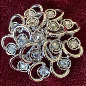 Pin-silver-tone & crystal stones in unique swirl design. Vintage Sarah Coventry